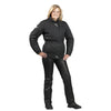 A woman standing and posing in black leather motorcycle trousers and boots.