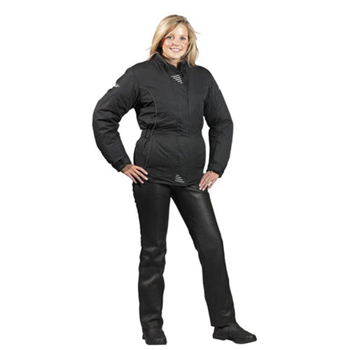 A woman standing and posing in black leather motorcycle trousers and boots.
