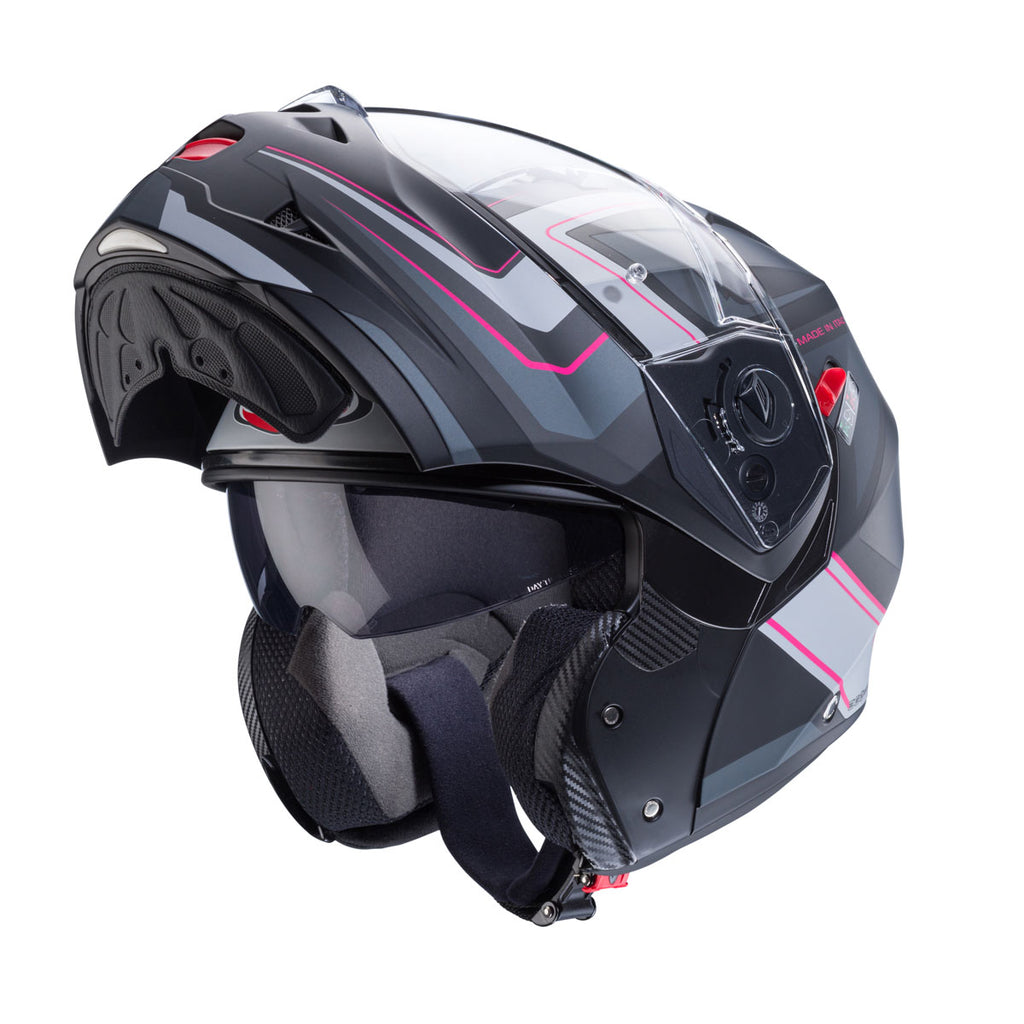 flipped up black and pink motorbike helmet with integrated sun visor